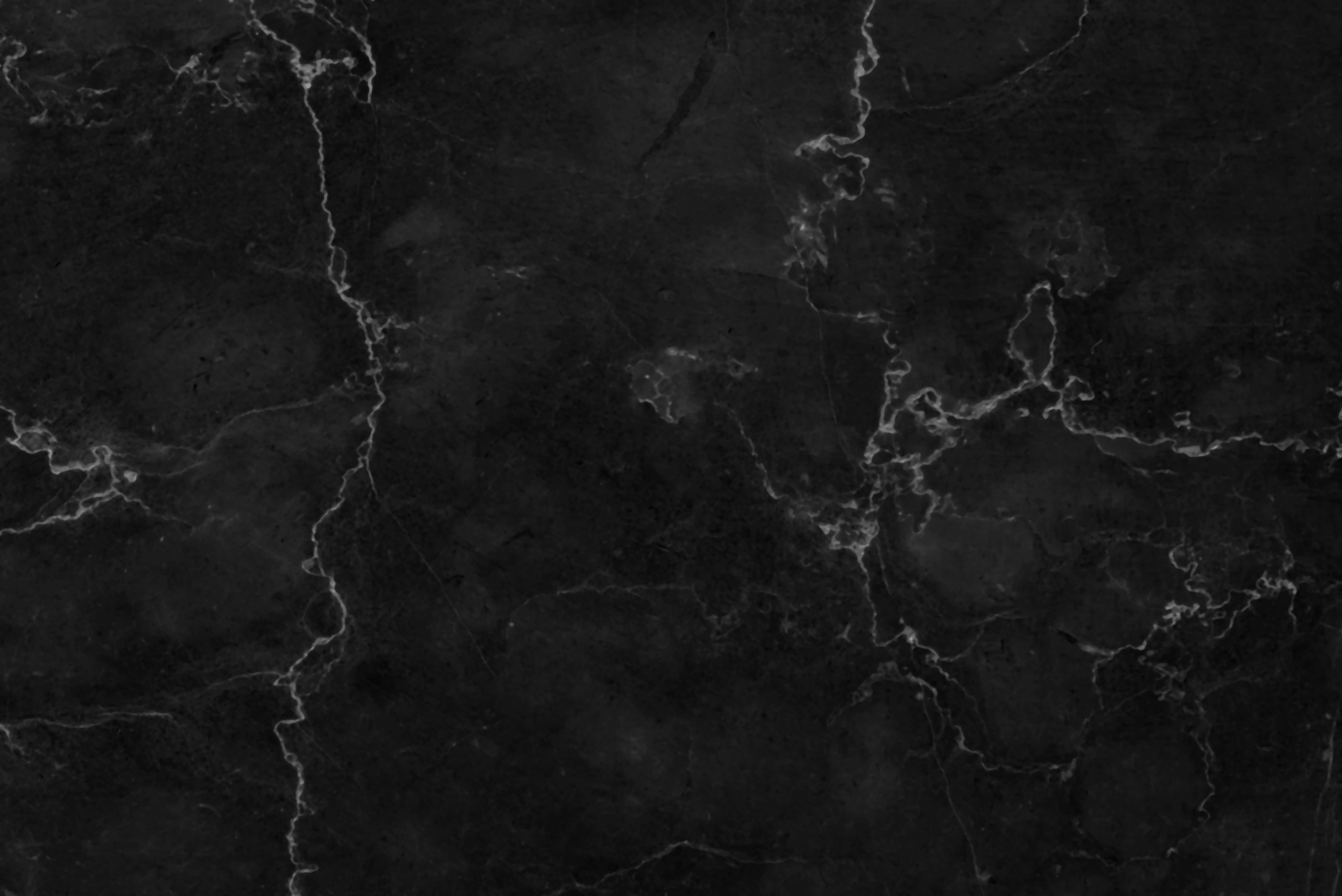 Dark marble texture with white veining patterns.