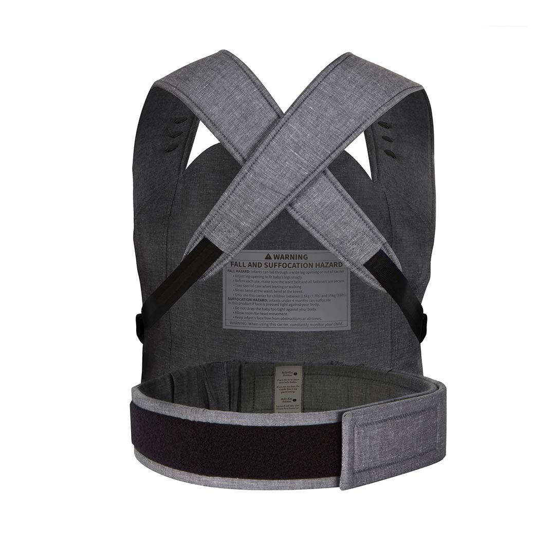 Back view of a grey fabric baby carrier with crossed shoulder straps and a prominent warning label.