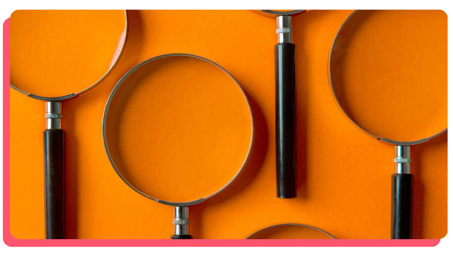 Several magnifying glasses on an orange background.