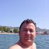 A person in the water with a beach in the background.