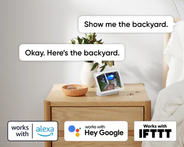 Smart display on a nightstand showing a backyard, with voice assistant logos below.