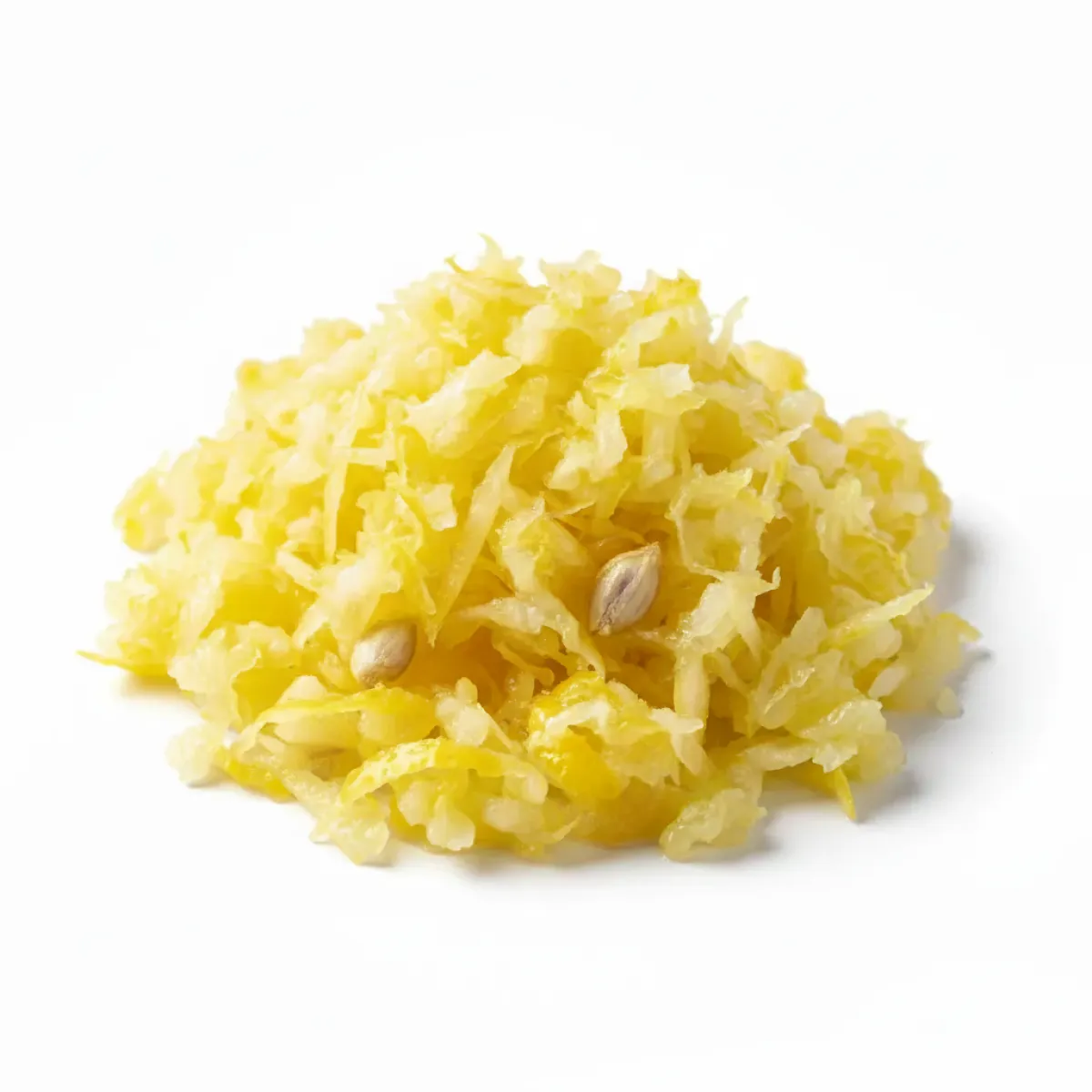 A small pile of shredded yellow lemon peel and pulp with a few seeds on a white background.