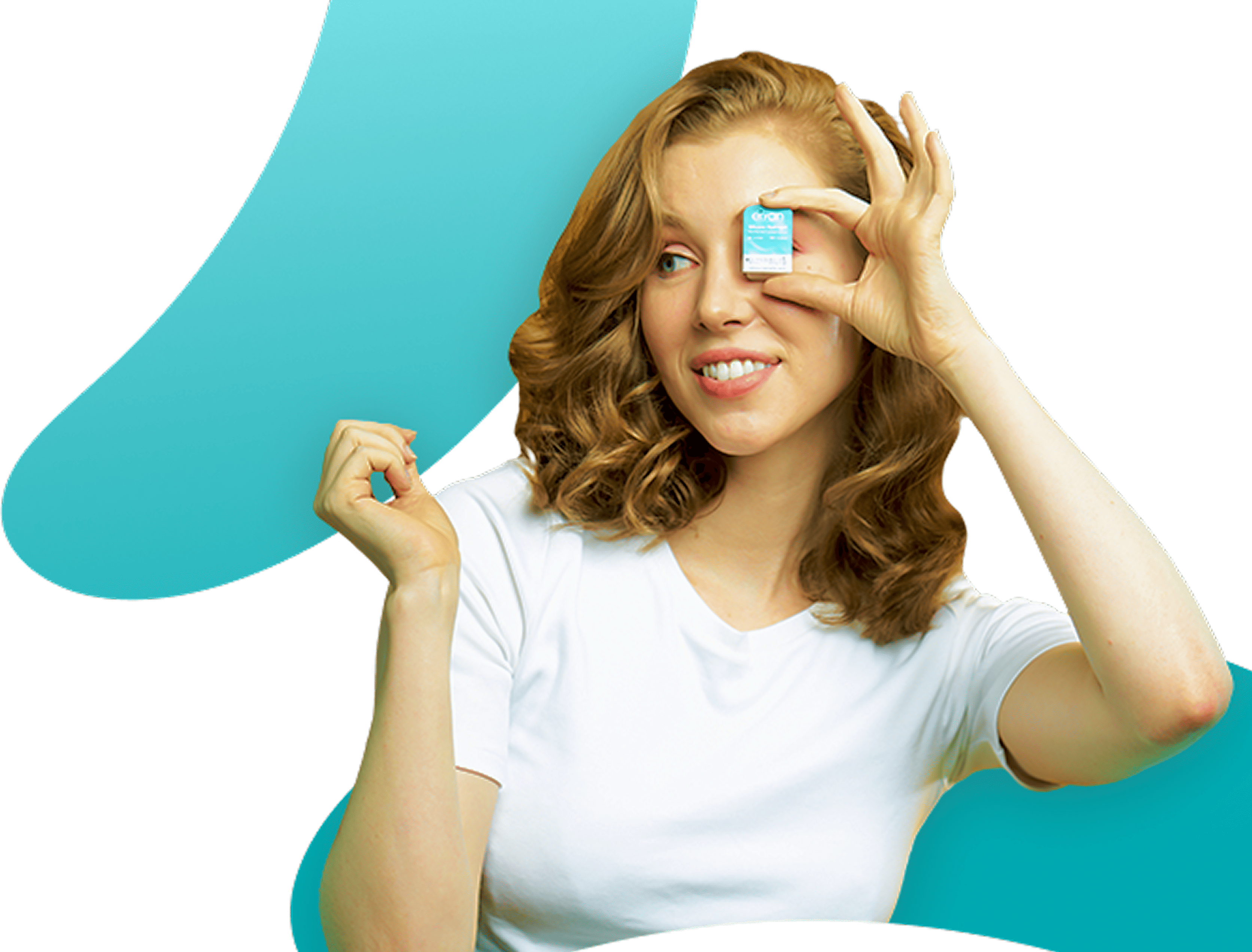 Woman holding a small product box in front of her eye, smiling.
