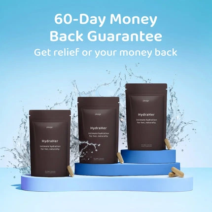 Three pouches of HydraHer supplements and capsules on a blue, tiered stand with a water splash background.