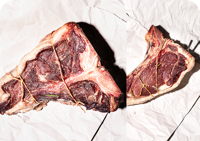 Two raw T-bone steaks tied with string on crumpled white paper.