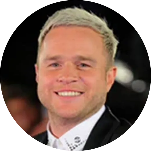 A circular headshot of a smiling man with short, light-colored hair, wearing a suit jacket and collared shirt.