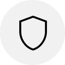 A black outline of a shield inside a light gray circle.