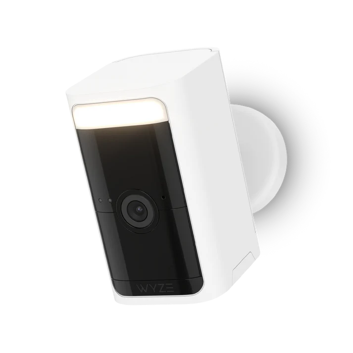 White security camera with a black lens and built-in light.