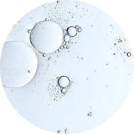 A circular macro shot of clear bubbles of various sizes suspended in a clear, light-blue liquid.
