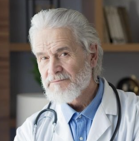 Elderly man with white hair and beard, wearing a doctor's coat and stethoscope.