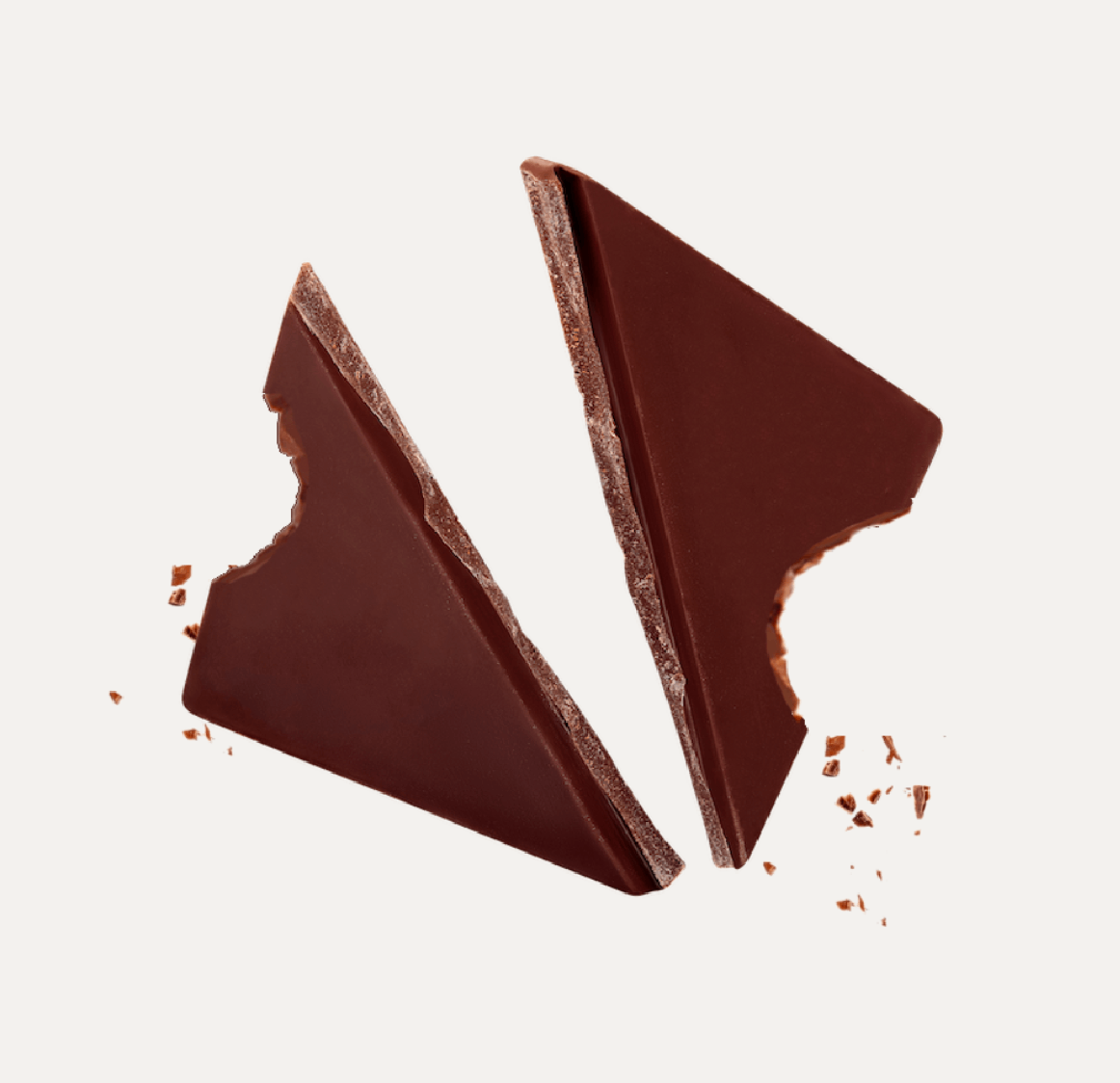 Two broken pieces of chocolate with bite marks and crumbs.