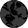 A dark gray circle with a black floral and leaf pattern on a green background.