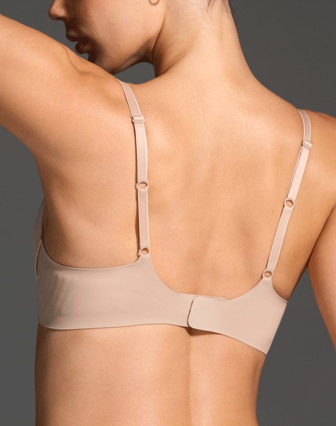 Back view of a person wearing a beige bra.