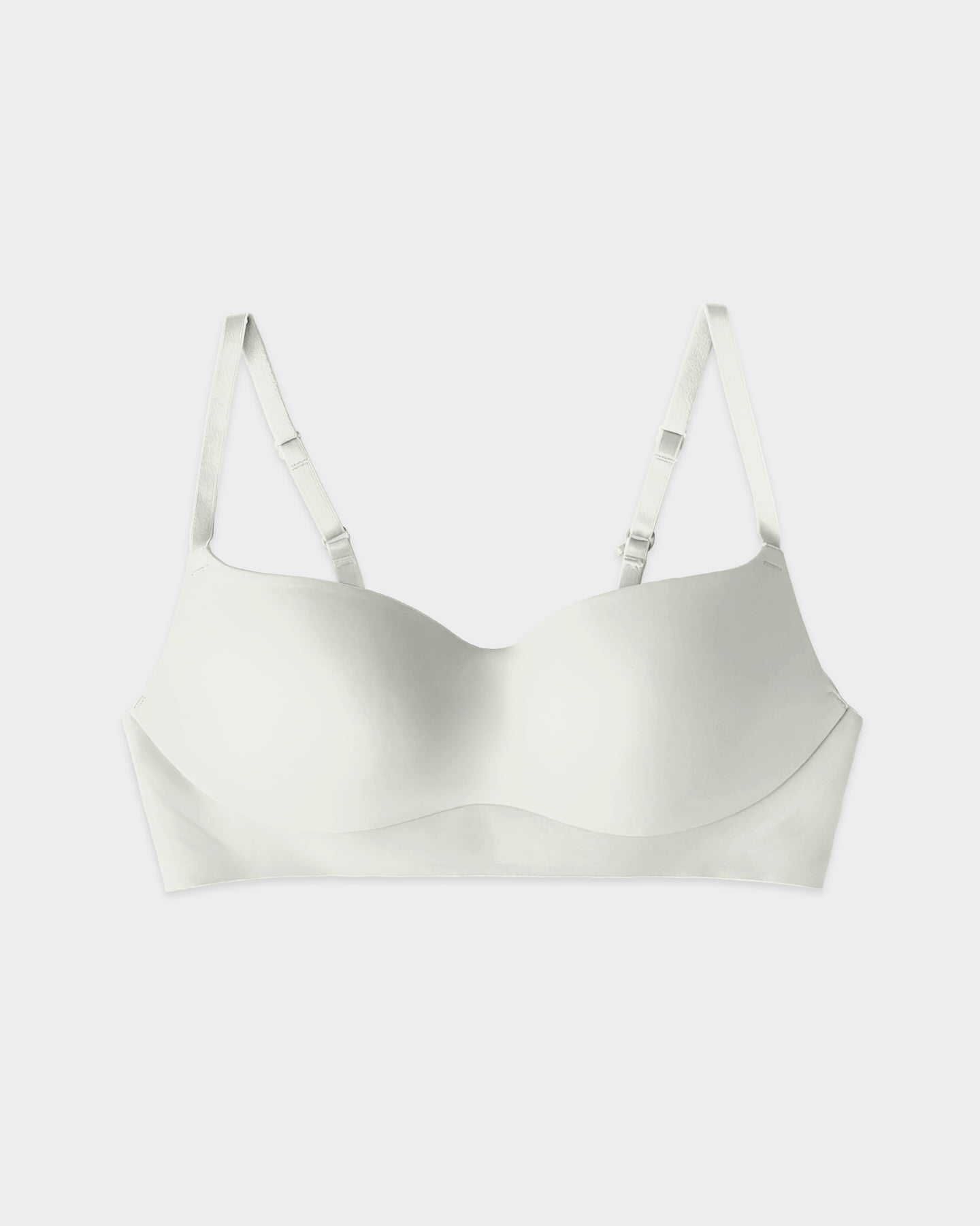 White bra with adjustable straps on a plain background.