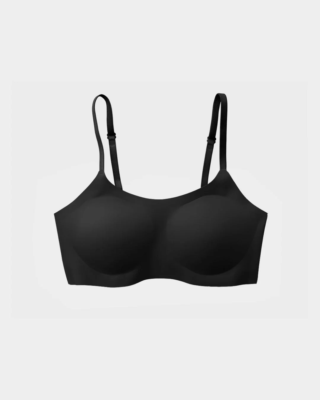A black seamless wireless bra with adjustable straps, shown against a light grey background.