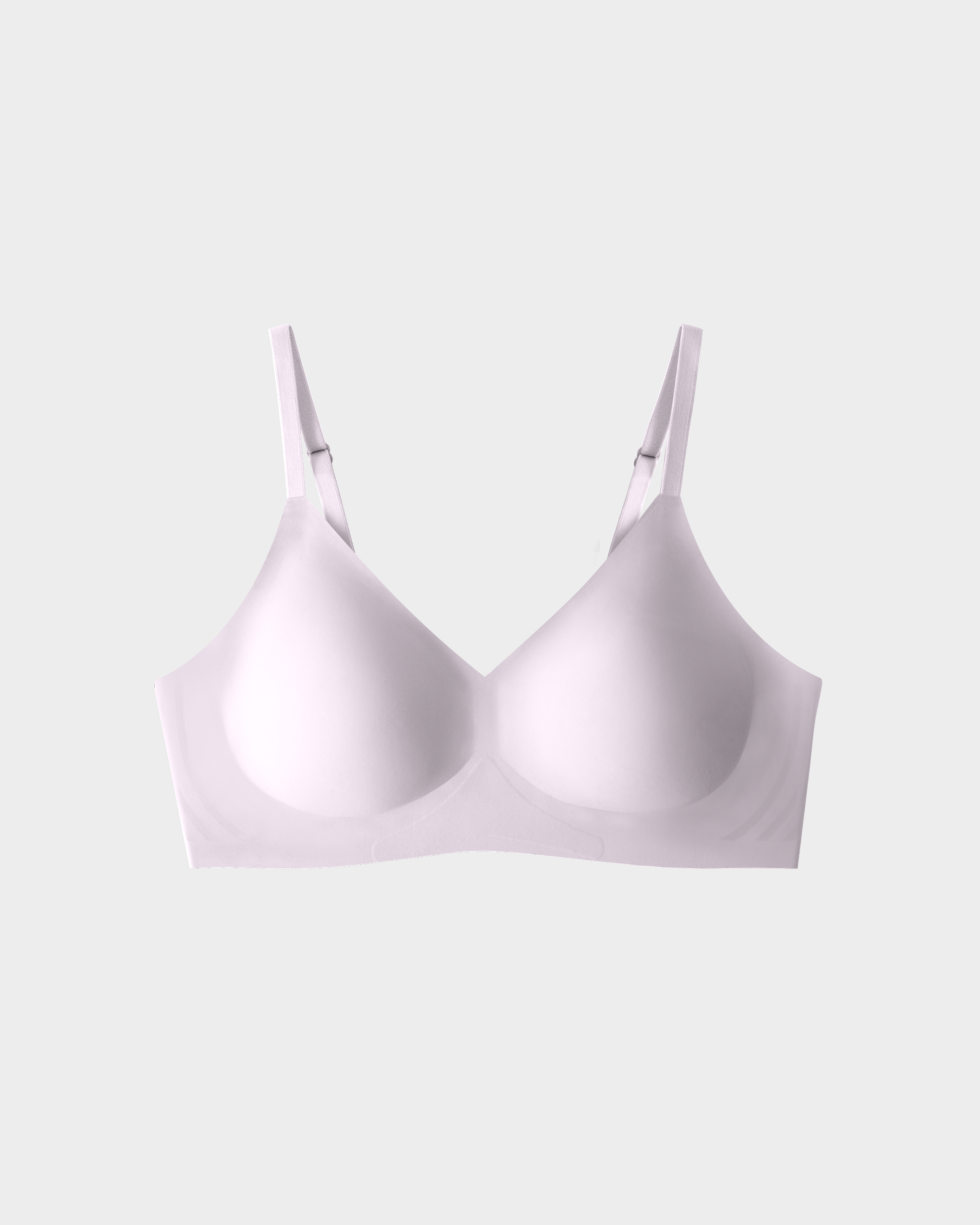 White seamless bra with adjustable straps on a neutral background.