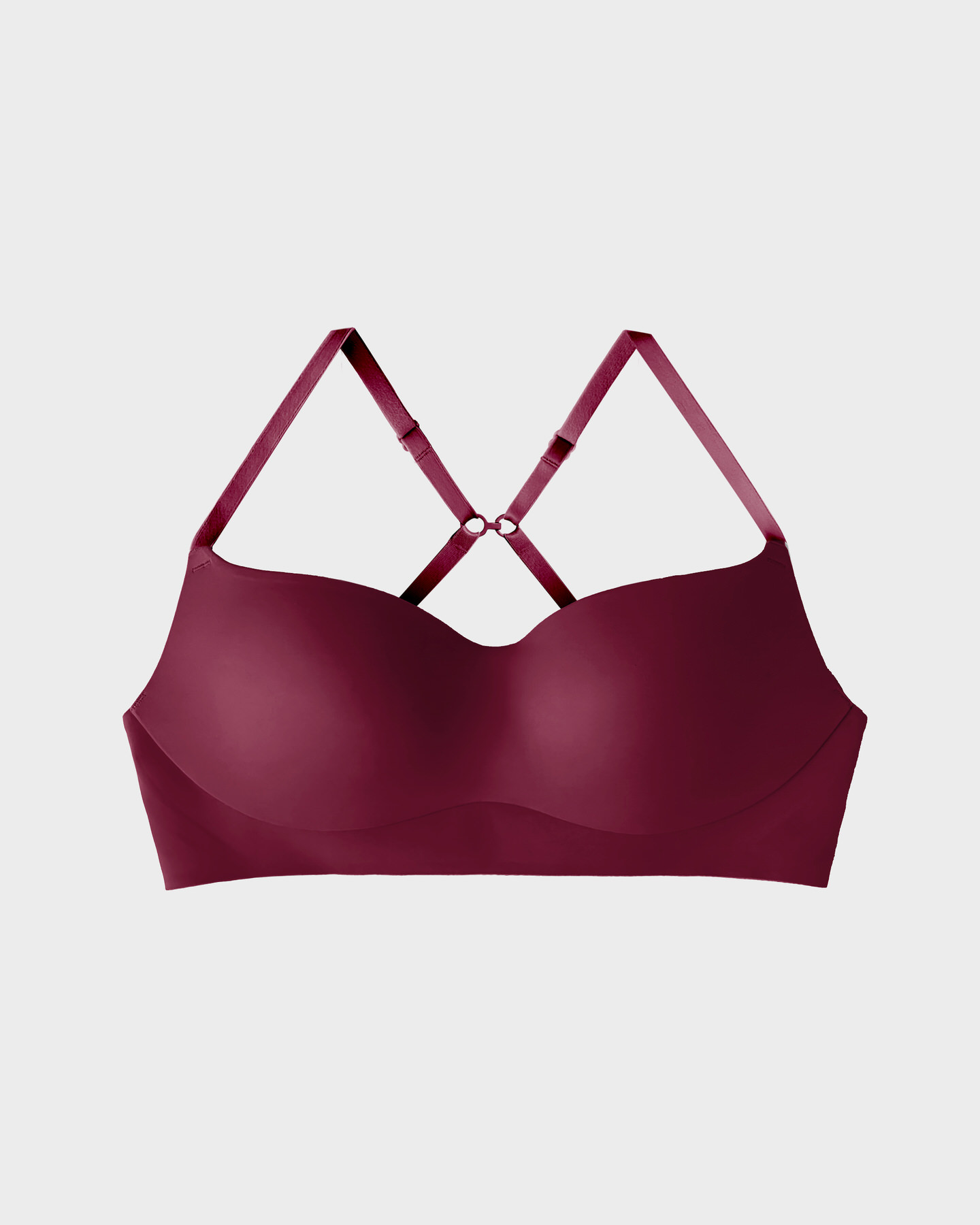 Maroon bra with crisscross straps on a white background.