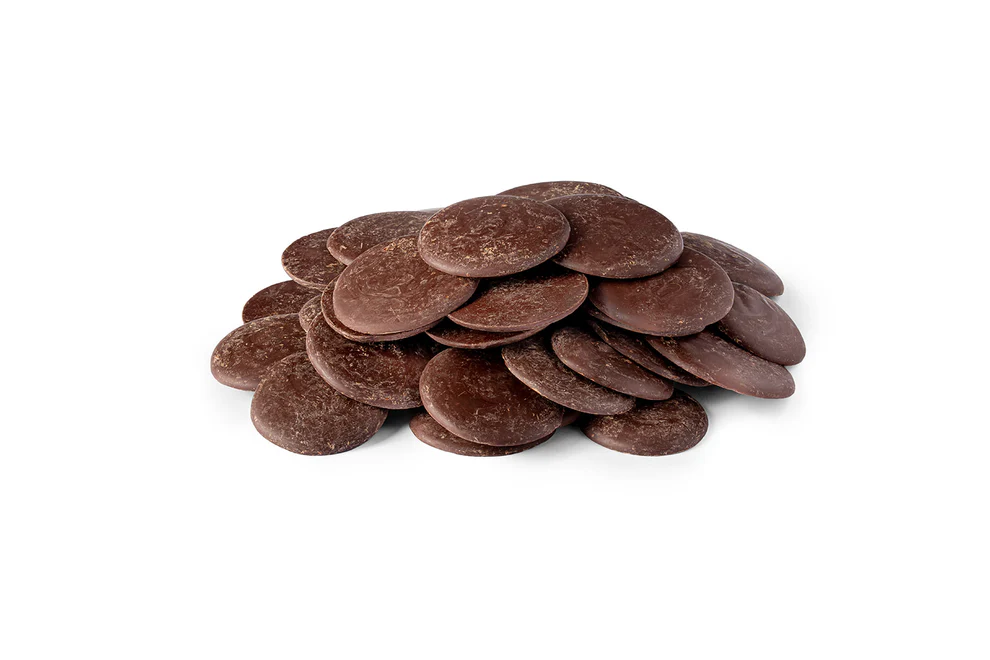 A small pile of round, flat chocolate melting wafers on a white background.