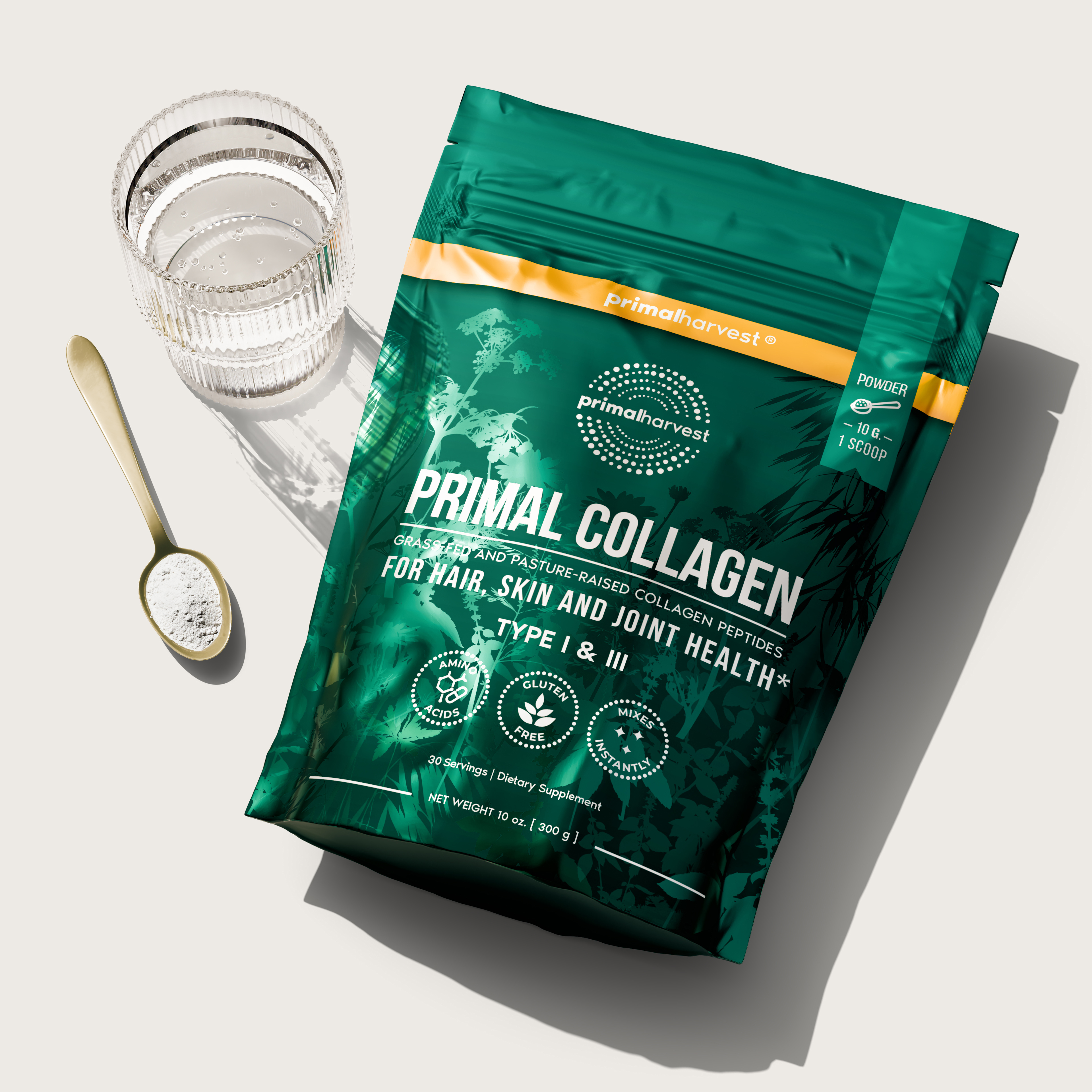 Primal Collagen package with a glass of water and a spoon of powder.