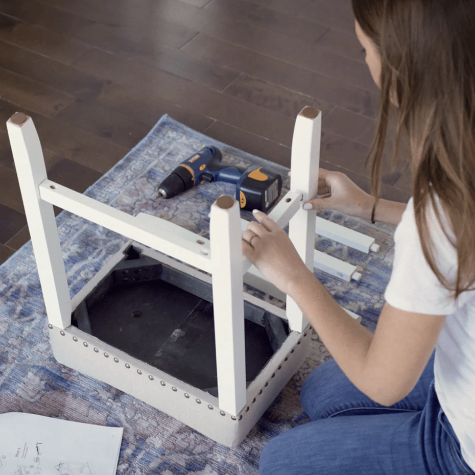 a woman embling a chair