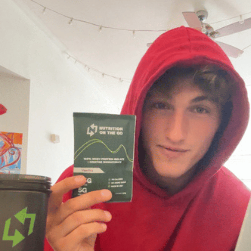 A customer holding a single serve packet of protein powder from nutrition on the go