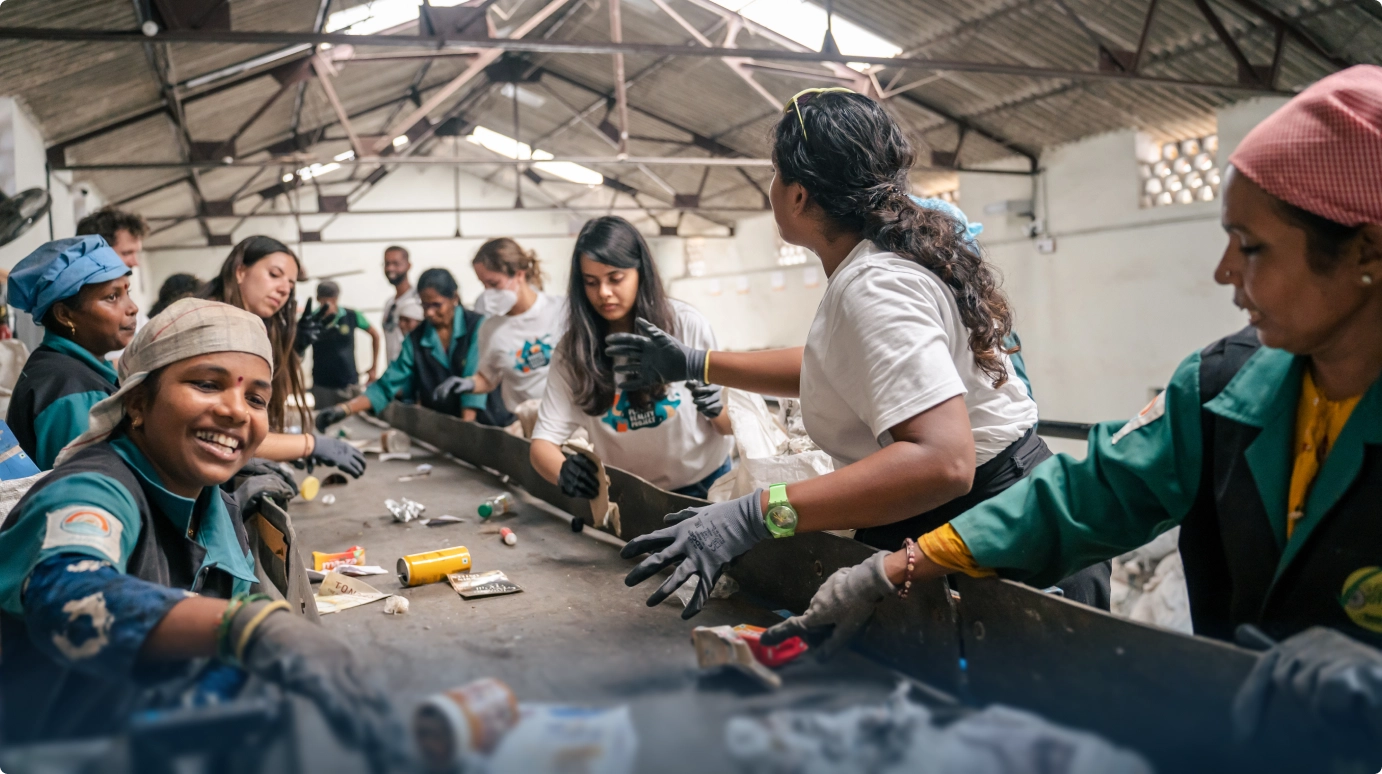 Workers sorting and weighing recovered plastic
