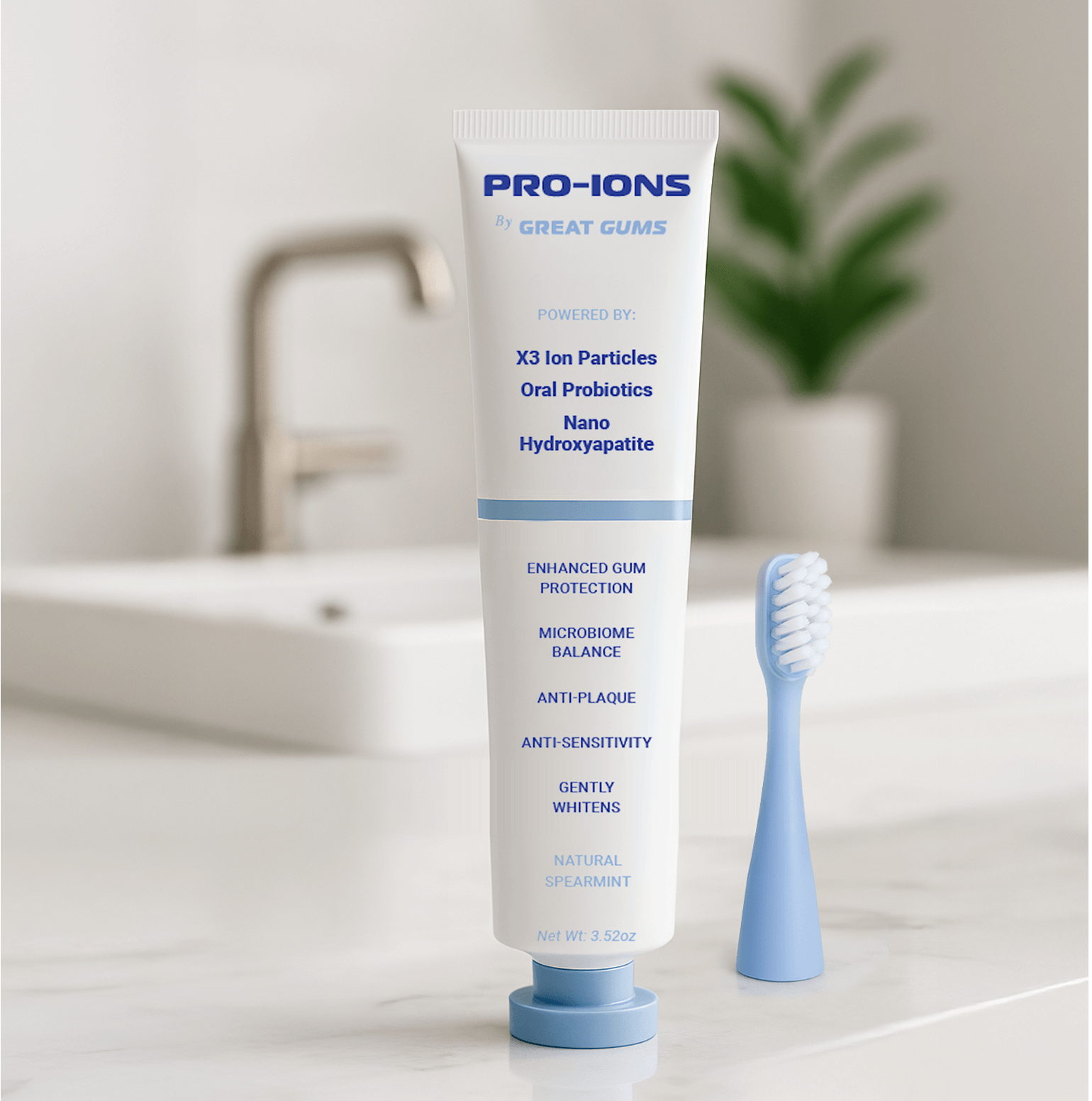 Toothpaste tube and toothbrush on a bathroom counter, plant in background.