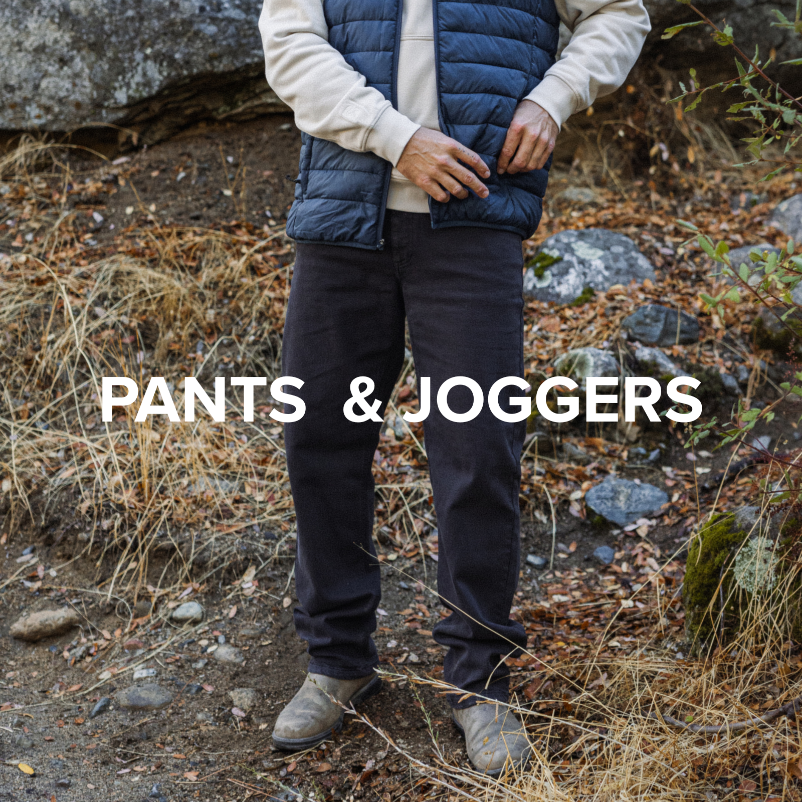 Man in Primaloft Packable Jacket Navy and  Stretch Travel Jean in Charcoal Black