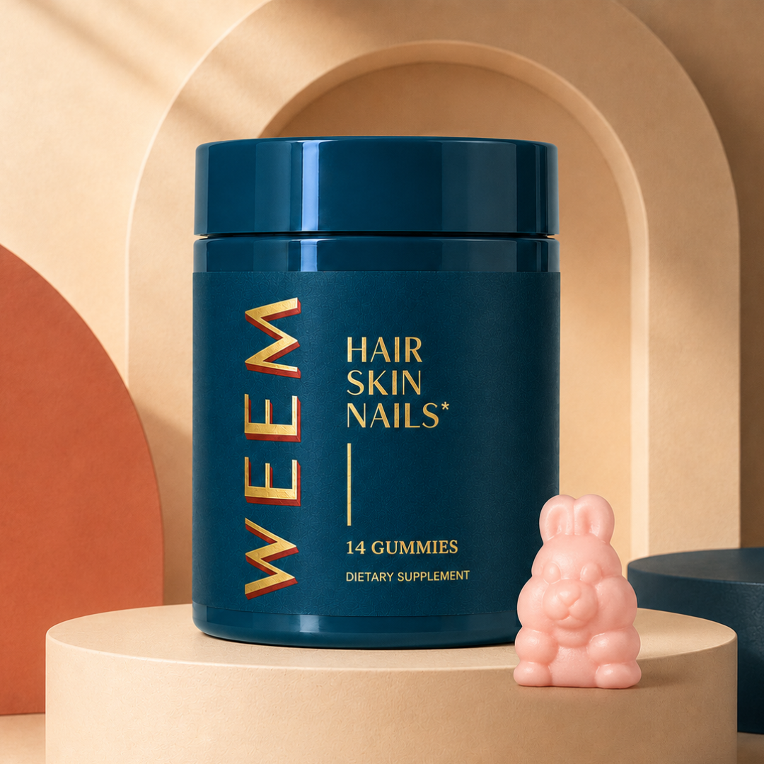 A teal jar of WEEM Hair Skin Nails gummies sits on a pedestal next to a pink bunny-shaped gummy.