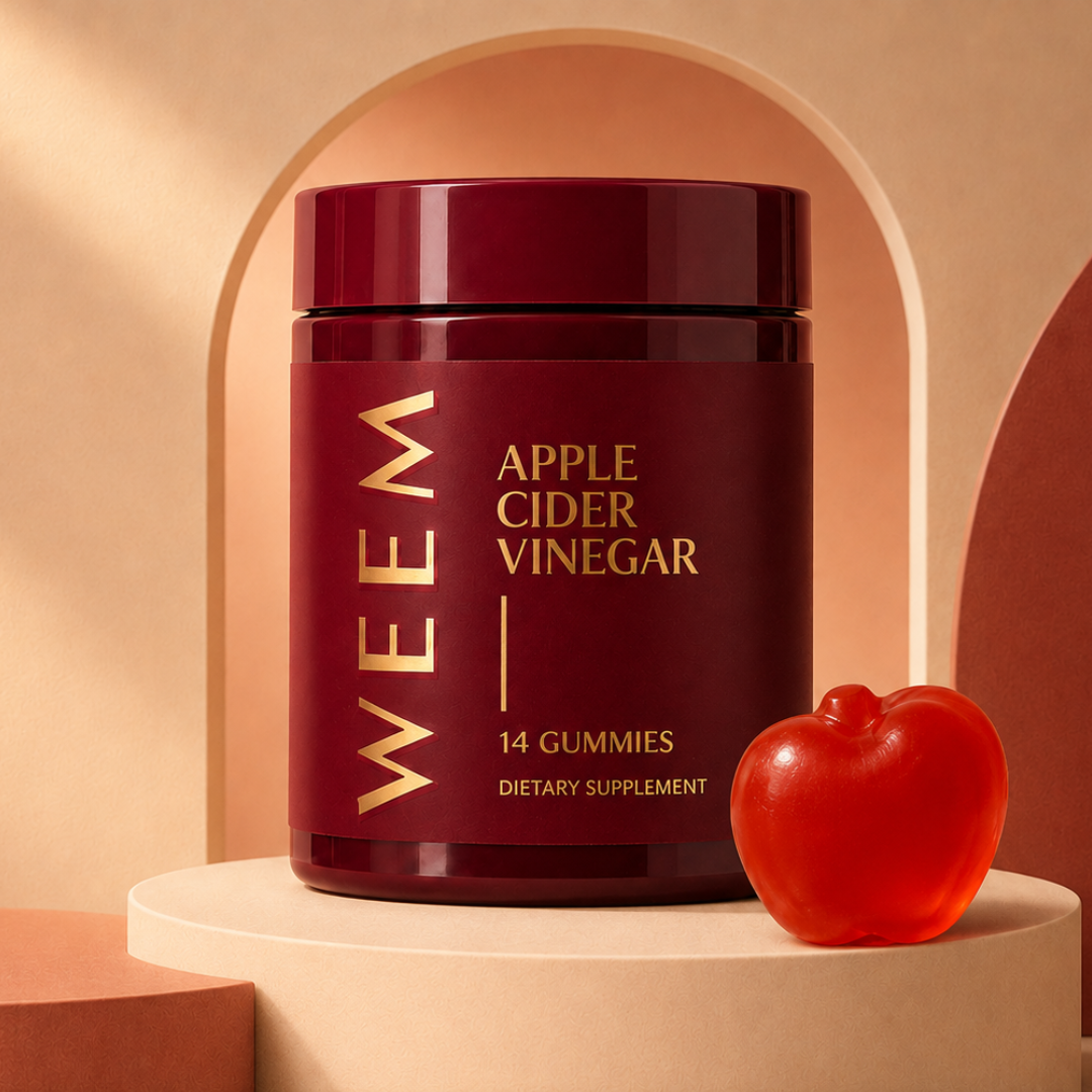 A bottle of WEEM Apple Cider Vinegar gummies on a pedestal next to a single red, apple-shaped gummy.