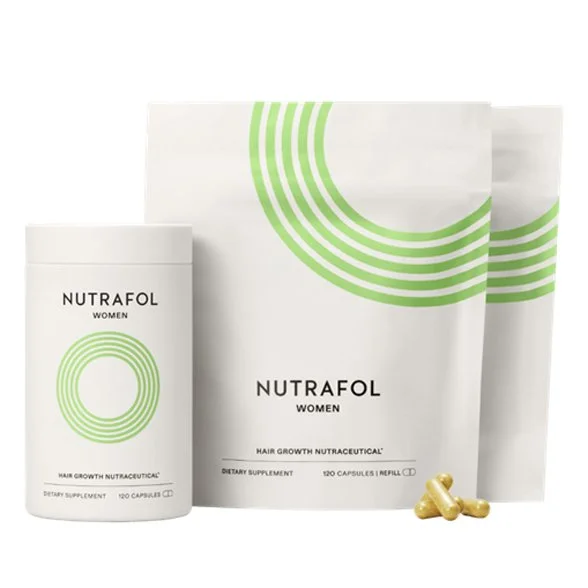 A bottle and two refill pouches of Nutrafol Women hair growth supplement, with a few capsules.