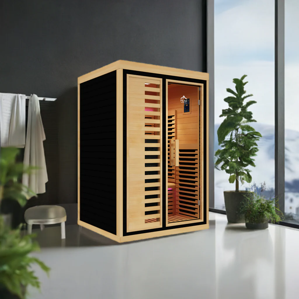 Modern wooden sauna in a bright room with plants and towels.
