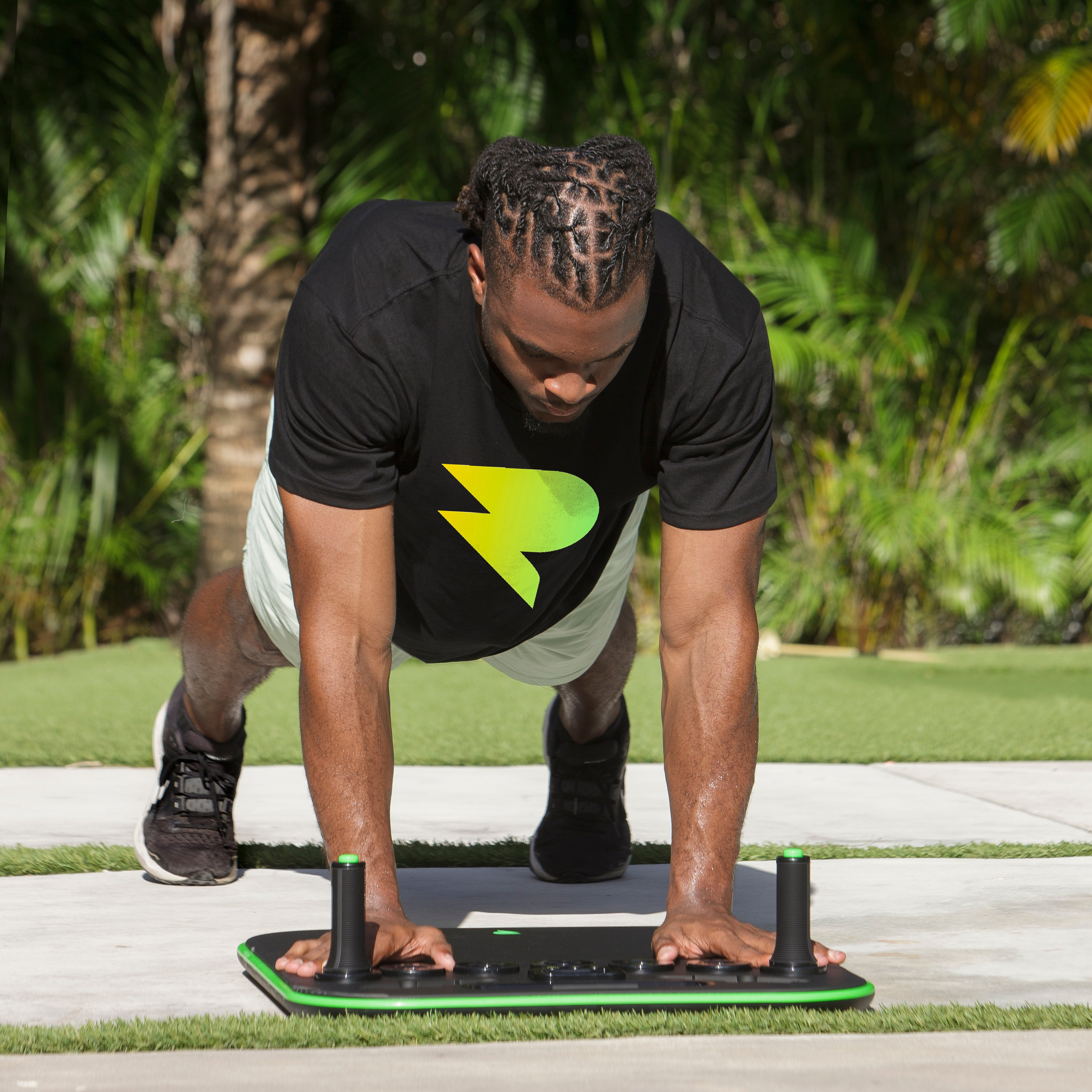 Person doing a plank exercise on a fitness board outdoors.