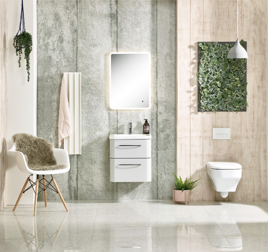 Modern bathroom with wall-mounted sink, toilet, and greenery decor.