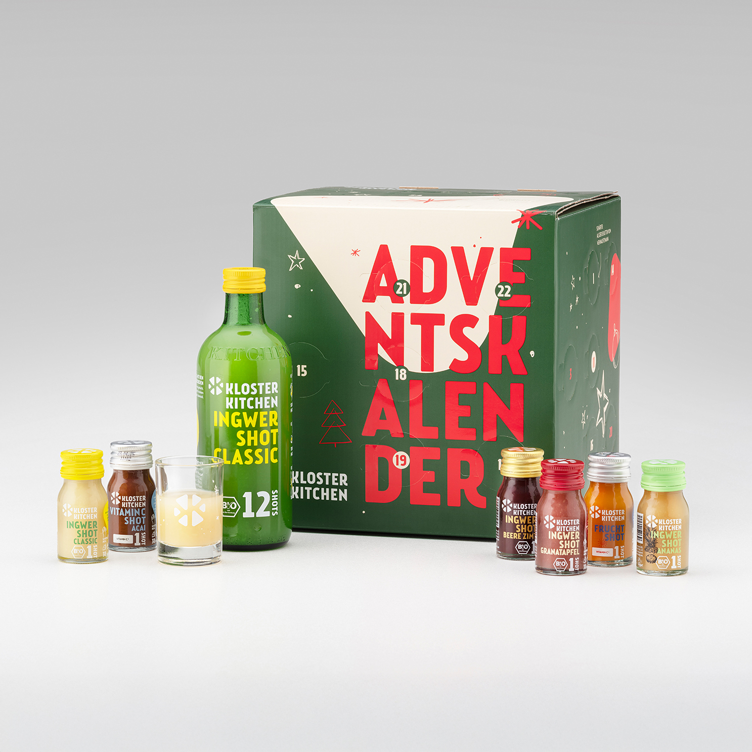 Advent calendar box with various small bottles and a large green bottle.