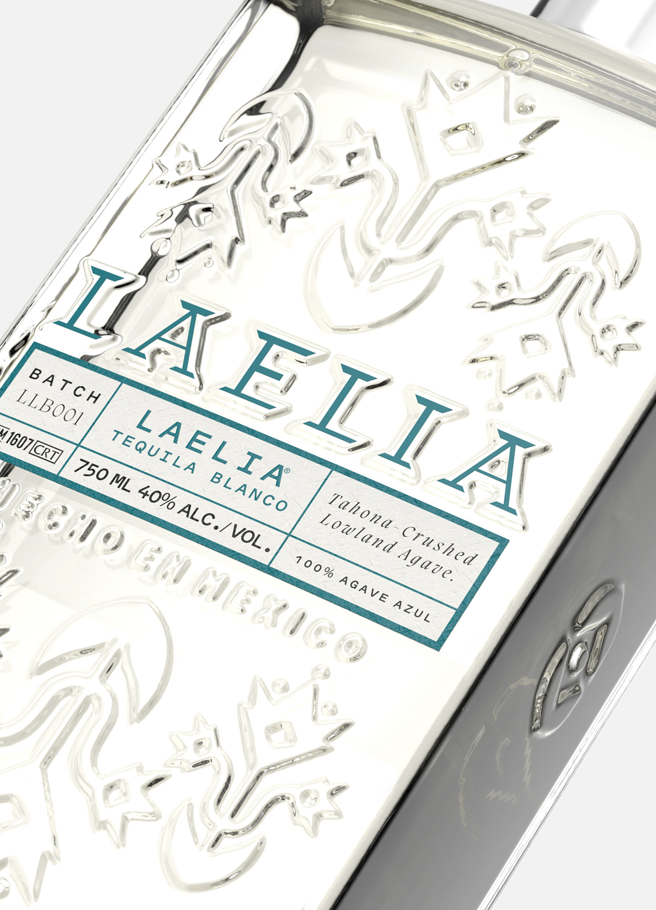 Close-up of a Laelia Tequila Blanco bottle with embossed floral design.