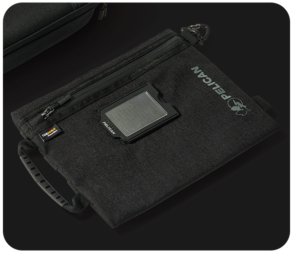 Black fabric bag with a handle and a small rectangular display.