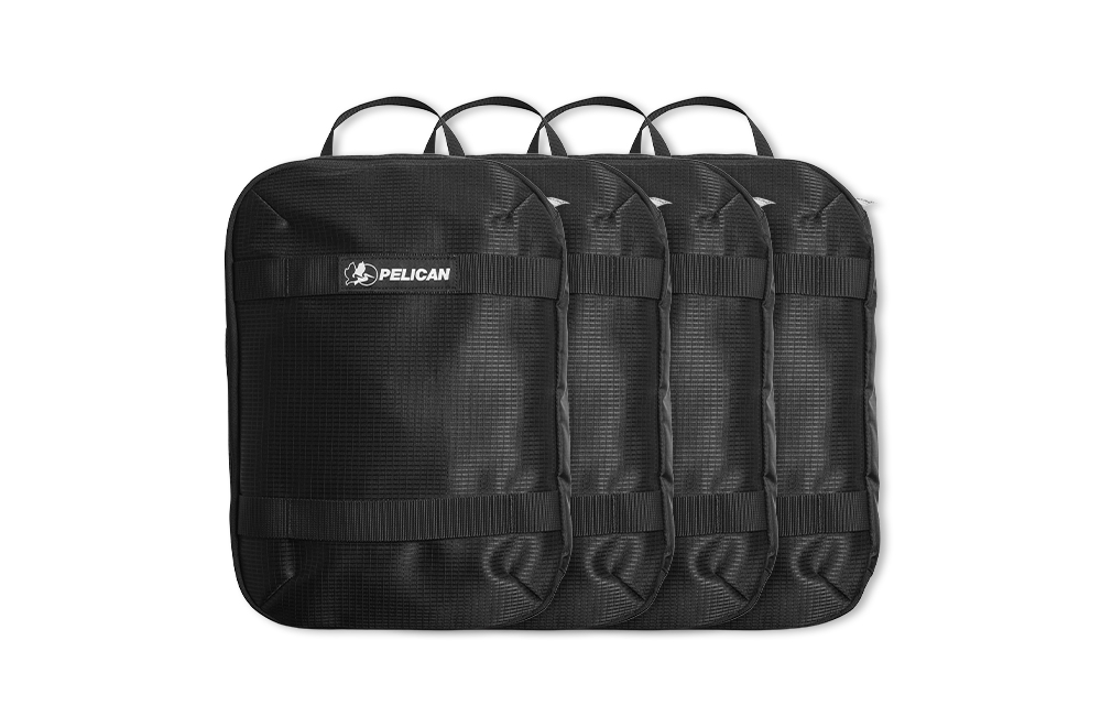 Four black Pelican backpacks lined up in a row.