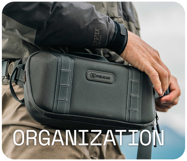 Person wearing a jacket holds a black Pelican case, 'Organization' text overlay.