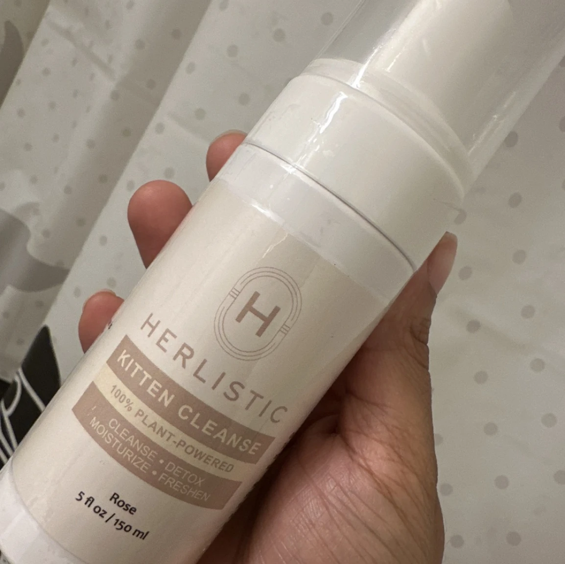 Hand holding a bottle of Herlistic Kitten Cleanse.