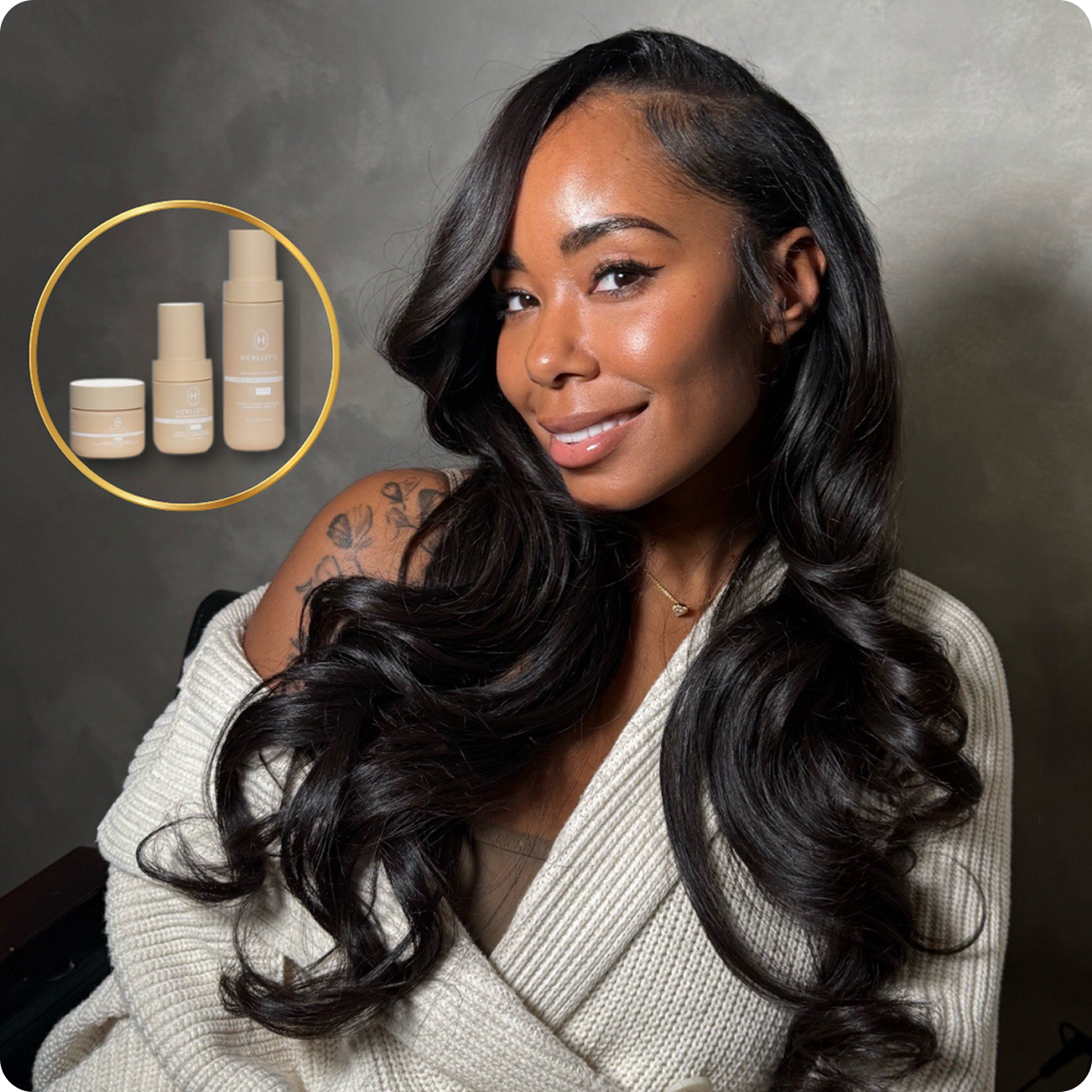 Smiling woman with long hair, wearing a white sweater, next to skincare products.