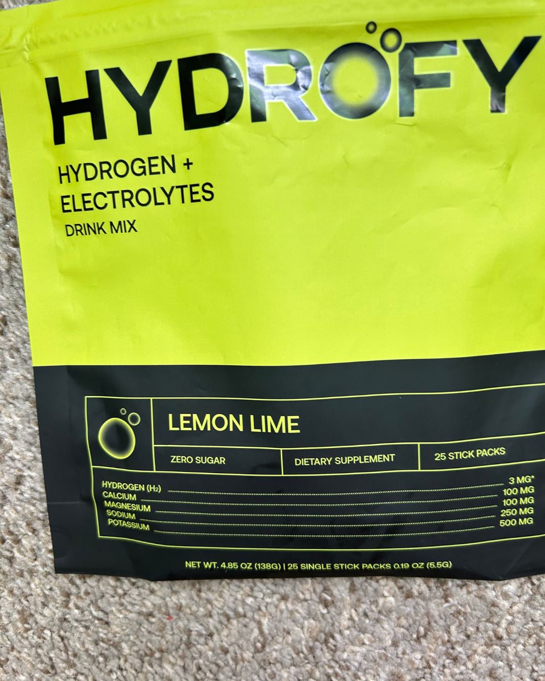 Hydrofy lemon lime hydrogen and electrolytes drink mix package on carpet.