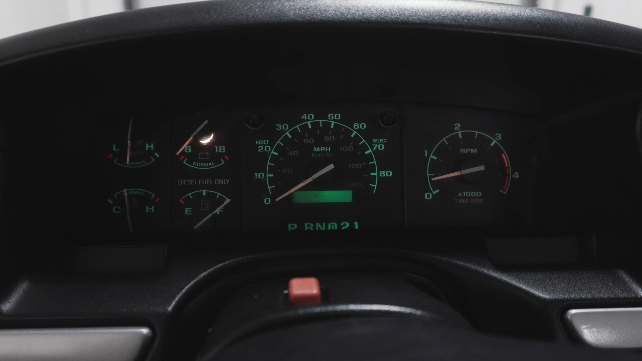 Close-up of a vehicle dashboard with speedometer and fuel gauge.