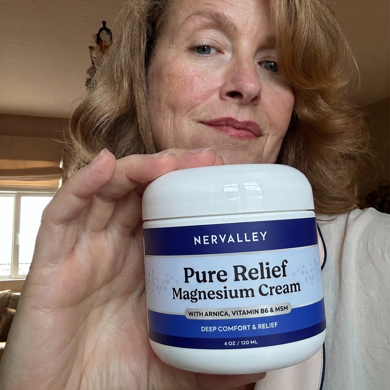 A woman holds up a jar of Nervalley Pure Relief Magnesium Cream, showing the label to the camera.