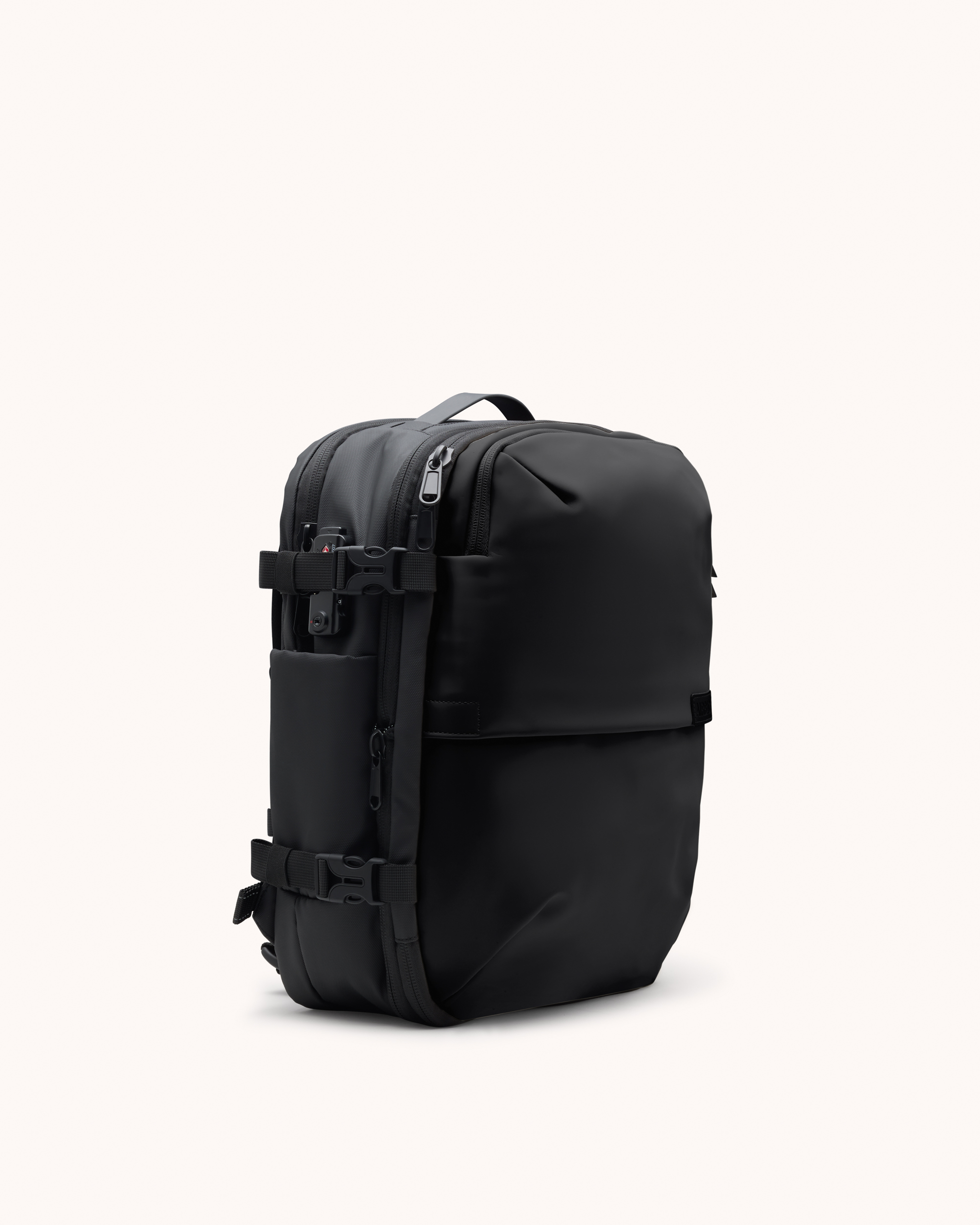 A modern, black backpack with side buckles and zippers, shown against a plain off-white background.