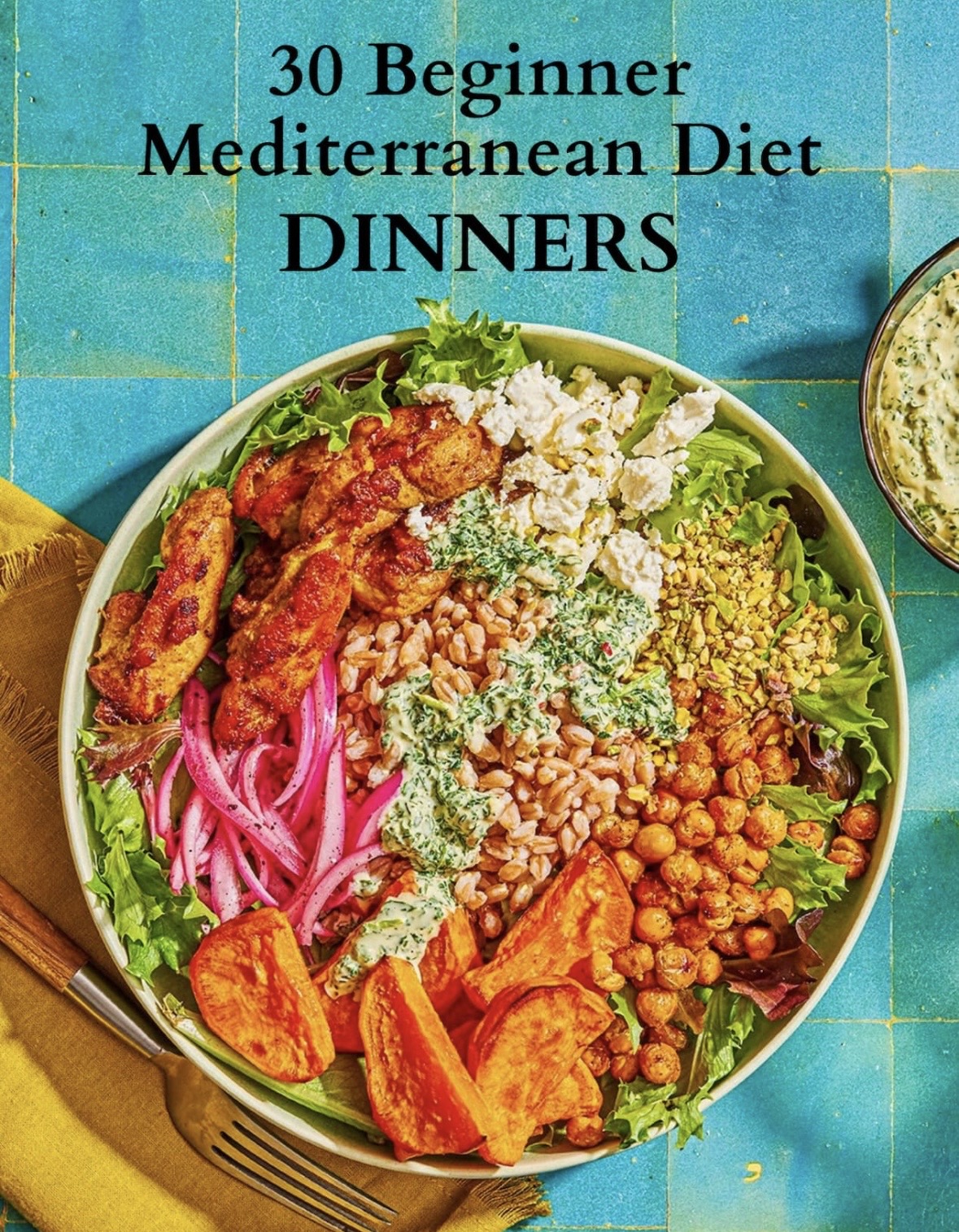 An overhead shot of a colorful Mediterranean grain bowl with chicken, sweet potatoes, chickpeas, and feta.