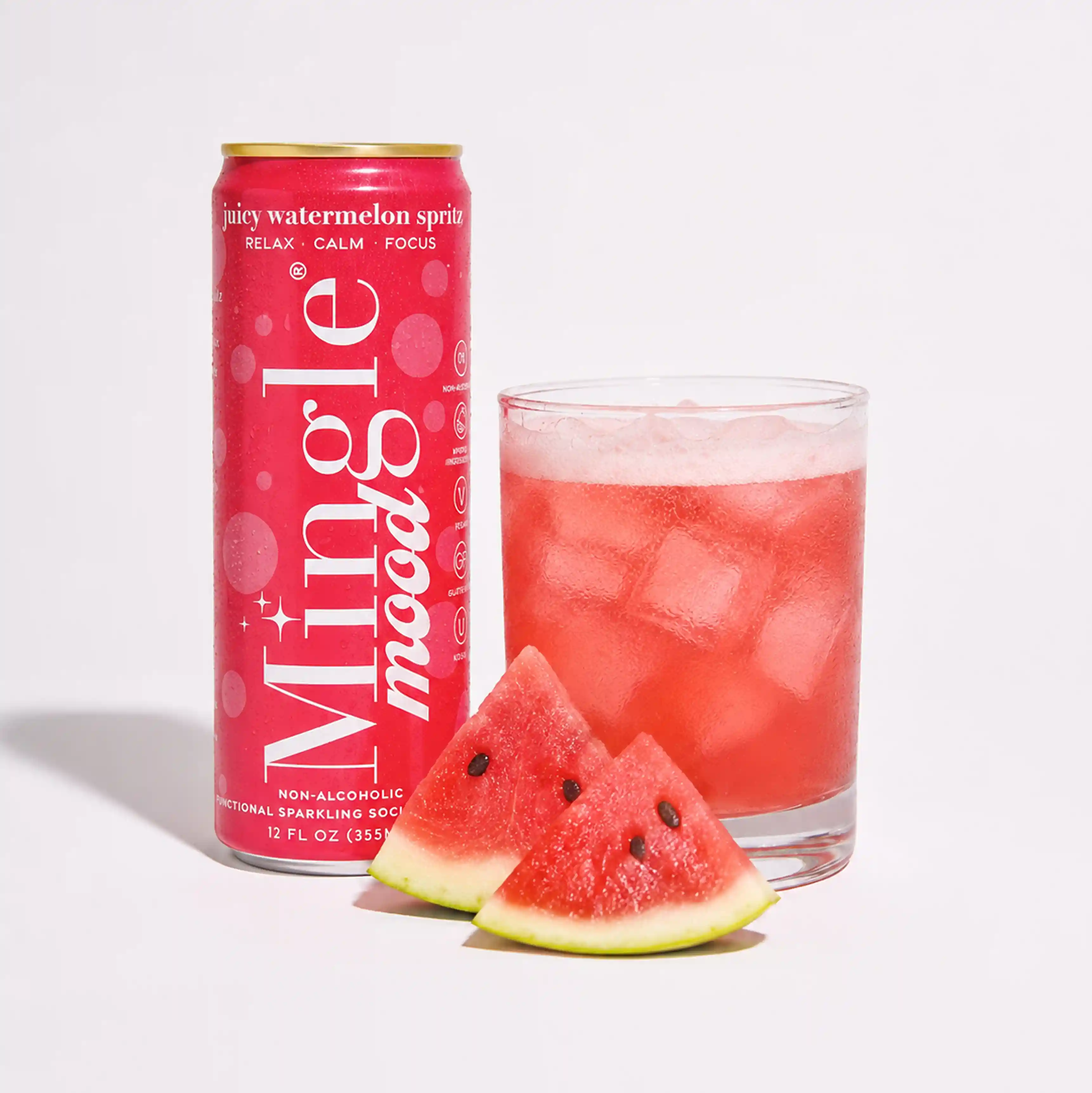 A can of Mingle Mood watermelon spritz next to a glass of the drink with fresh watermelon slices.