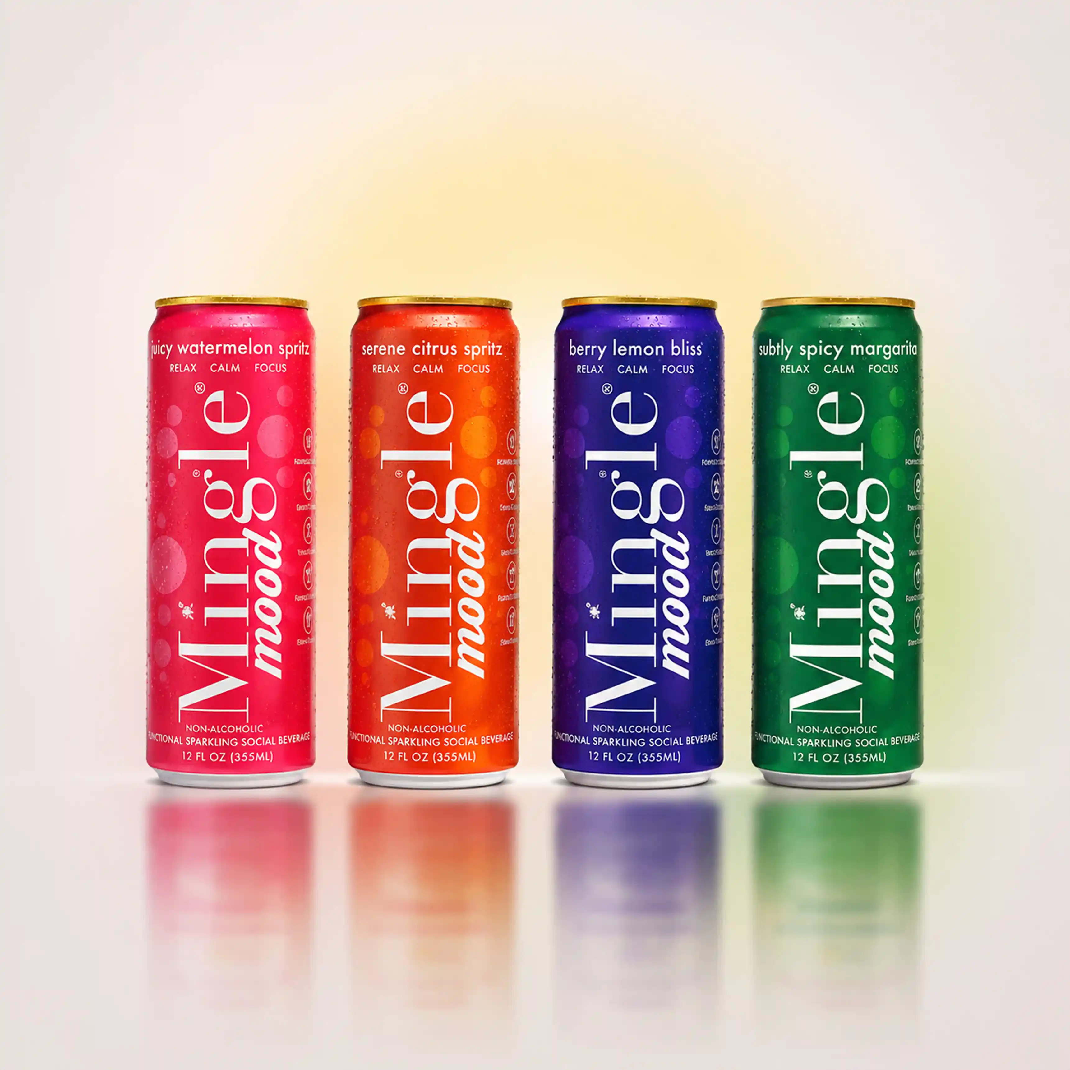 Four colorful, condensation-covered cans of Mingle Mood non-alcoholic sparkling beverages lined up on a reflective surface.