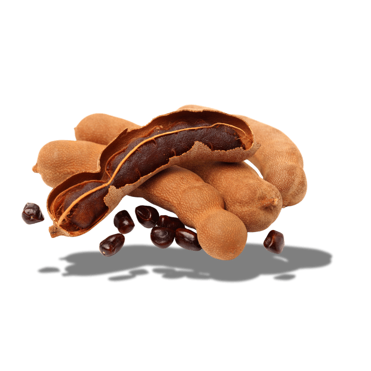 A cluster of tamarind pods, one broken open, with seeds scattered on a white background.