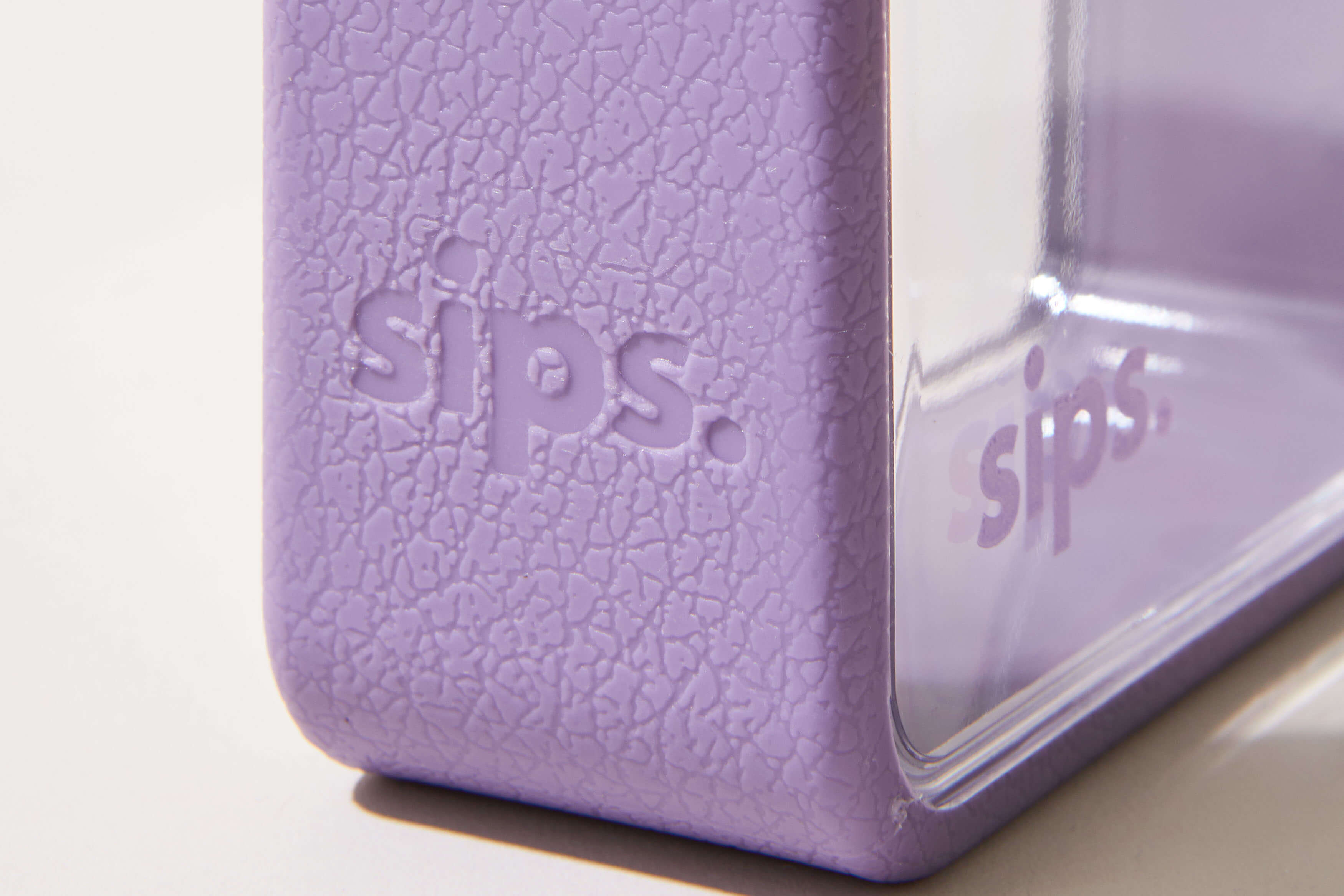 Close-up of a textured purple object with 'sips.' embossed.